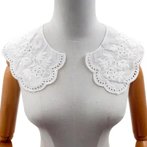 Macro detail view of white floral eyelet embroidered lace fake collar on a mannequin