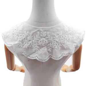 Close-up of white floral embroidered detachable collar with elegant hollowed-out lace details.