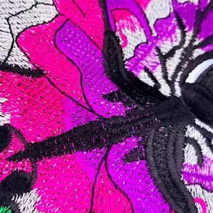 Detailed macro view of colorful butterfly lace embroidery patch for DIY sewing and crafts