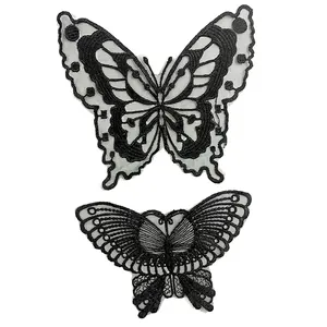Detail showing two different styles of black embroidered butterfly lace patches