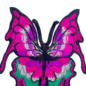 Macro view of detailed butterfly embroidery patch with vibrant pink and purple threads