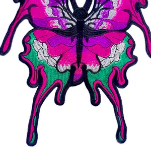 Macro view showing the intricate detail of a colorful butterfly embroidery patch with pink thread