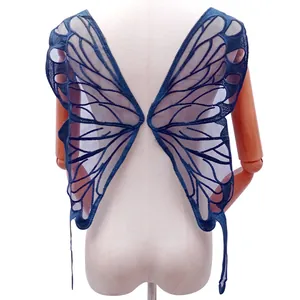 Close-up of the delicate navy blue embroidered butterfly wing lace appliqué on a mannequin.