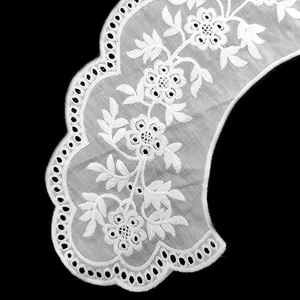 Close-up of white floral embroidered lace collar with delicate punchwork details