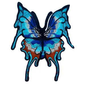 Close-up detail of a blue butterfly lace embroidery patch with intricate stitching