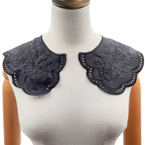 Macro detail of black floral embroidered eyelet lace decorative fake collar piece