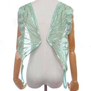 Detailed view of mint green butterfly wing embroidery applique on lace mesh backing