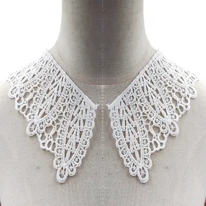 Close-up detail of white hollowed-out water-soluble embroidered lace fake collar