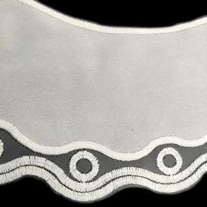 Macro view of white embroidered organza lace collar featuring delicate scalloped edges