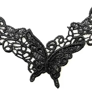 Macro view of detailed black butterfly lace embroidery applique for DIY necklines.