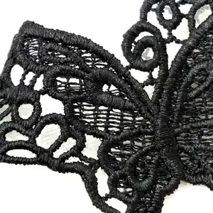 Detailed macro view showing the intricate black water-soluble butterfly lace embroidery texture