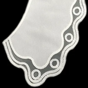Macro detail of white embroidered lace doll collar with organza base for kids apparel