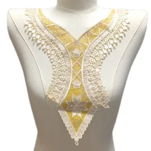 Détail en gros plan du col en dentelle brodée jaune et blanc, applique soluble à l'eau