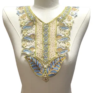 Détail d'un col en dentelle brodée colorée avec sequins sur un mannequin blanc