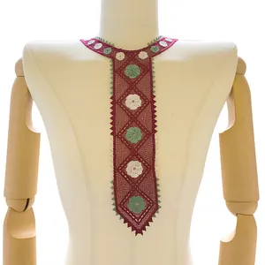 Detailed view of a colorful embroidered lace collar piece in necktie shape for garments.