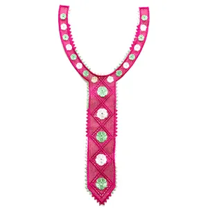 Detailed macro view of vibrant pink embroidered lace neck collar with floral motifs
