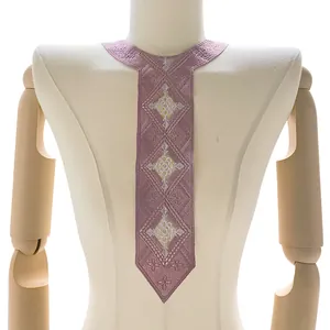 Detail view of a purple embroidered lace tie-shaped collar on a professional mannequin.