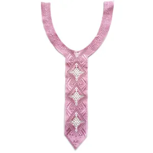 Close-up of pink embroidered lace collar patch with intricate geometric patterns