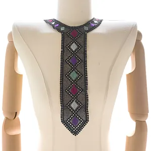 Detail showing colorful diamond embroidery on black lace tie-shaped false collar