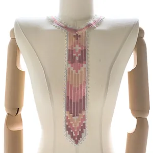 Close-up of a colorful geometric embroidered lace collar piece in a tie shape on mannequin