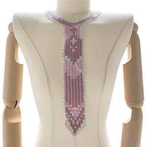 Close-up of colorful embroidered lace collar with purple tie-shaped pattern on mannequin