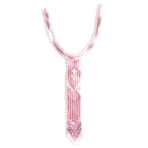 Detailed close-up of pink embroidered lace collar accessory
