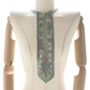 Detailed view of green embroidered lace collar applique with floral patterns on mannequin