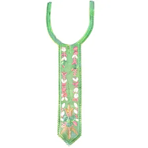 Close-up detail of green embroidered lace collar patch with pink floral patterns
