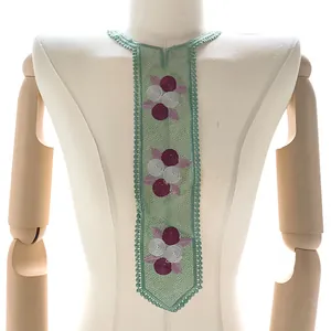 Detailed view of green embroidered lace collar on a mannequin torso