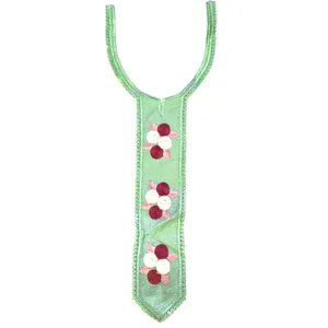 Macro view of mint green lace collar with burgundy and white floral embroidery details