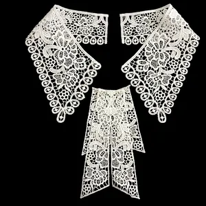Detailed view of intricate white water-soluble lace collar and bow appliqué set