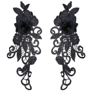 Detail of black 3D embroidered lace floral patches with intricate rose design.