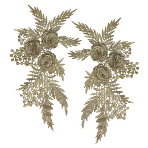 Detailed view of pair of symmetrical 3D golden lace floral embroidery patches