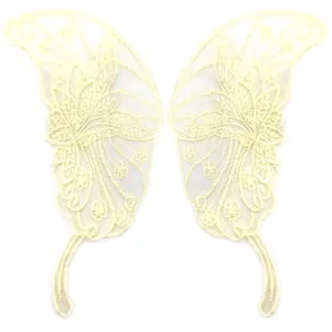 Detailed macro view of symmetrical beige lace butterfly appliques for DIY sewing crafts