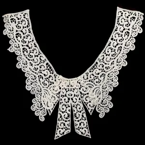 Detailed view of a white water-soluble lace fake collar with an elegant bowknot