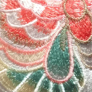 Close-up macro detail of colorful ethnic floral embroidery patch with gold thread stitching