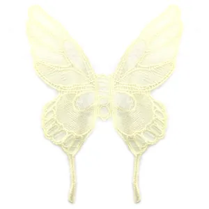 Detailed macro shot of a beige lace butterfly embroidery patch with fine mesh texture