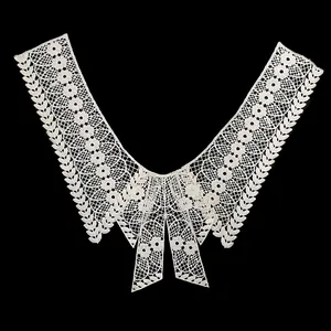 Detailed macro view of white water-soluble lace collar with intricate floral patterns
