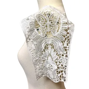 Close-up view of intricate white water-soluble lace embroidery applique on a mannequin