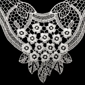 Detailed macro view of white water-soluble lace collar featuring delicate floral embroidery
