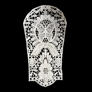 Detailed view of white water-soluble embroidered lace patch with butterfly motif