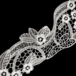Close-up of white water-soluble embroidered lace trim with detailed floral patterns