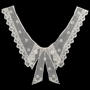 Detailed macro view of white water-soluble lace collar with delicate floral embroidery