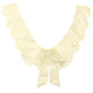 Close-up detail of a cream-colored water-soluble embroidered lace fake collar with bowknot