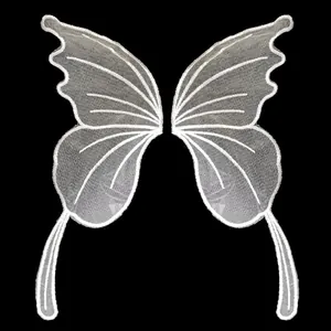 Detailed texture of symmetrical white mesh lace embroidered butterfly wing applique patches