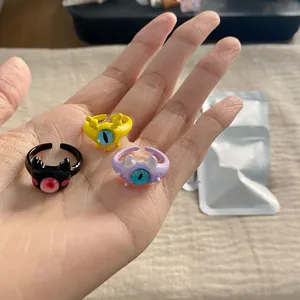Three cute cartoon monster open rings displayed on a palm