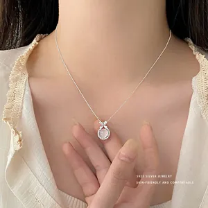 Primo piano di una collana in argento S925 con ciondolo in agata bianca e fiori