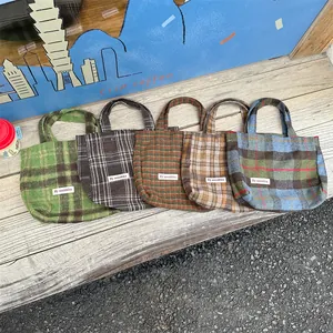 Detailed view of vintage plaid woolen tote bags in multiple colors, cozy autumn winter style.