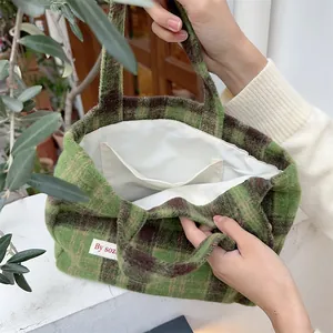 Detailed view of a retro green plaid wool tote bag for women featuring an inner pocket.