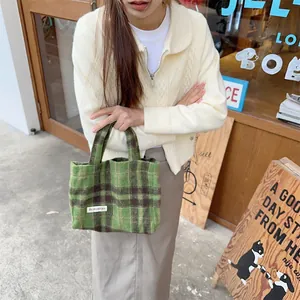 Green brown plaid woolen handbag detail, classic vintage tote bag for women chic style.